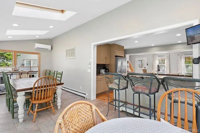 a dining room with furniture and a livingroom view