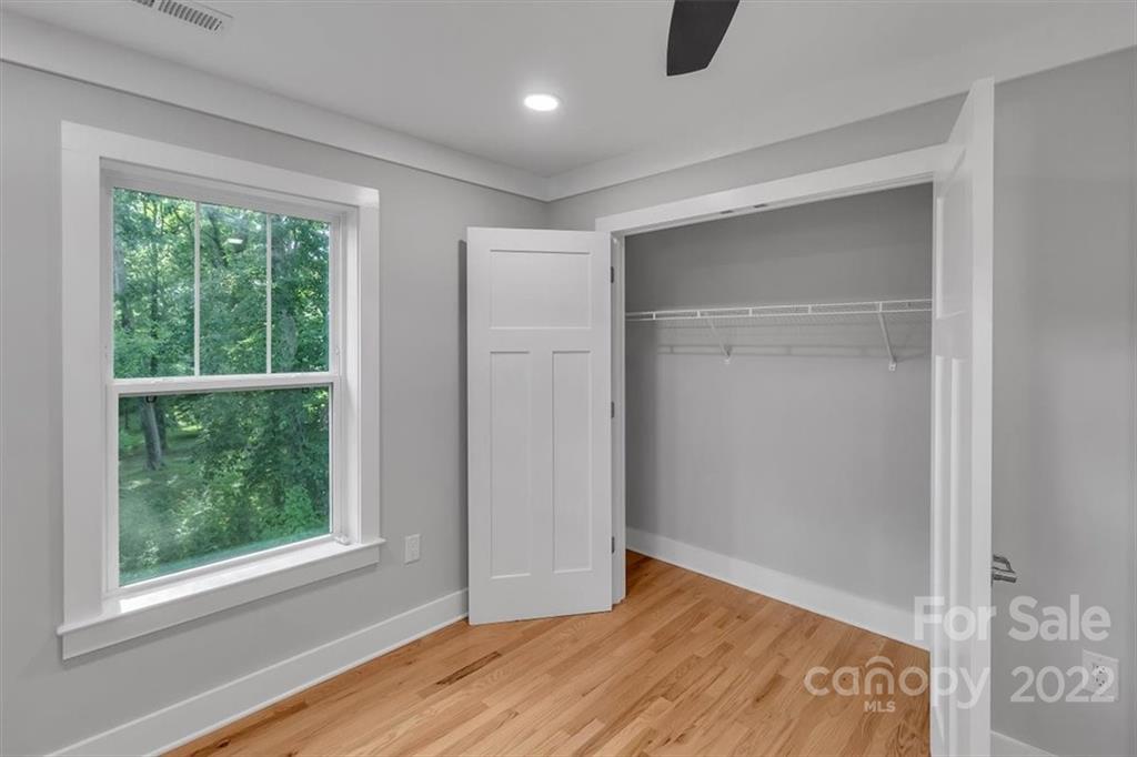 225 Ridge View Drive, Unit 16 Clyde, NC 28721 - Photo 25 of 29 a view of an empty room with wooden floor and a window