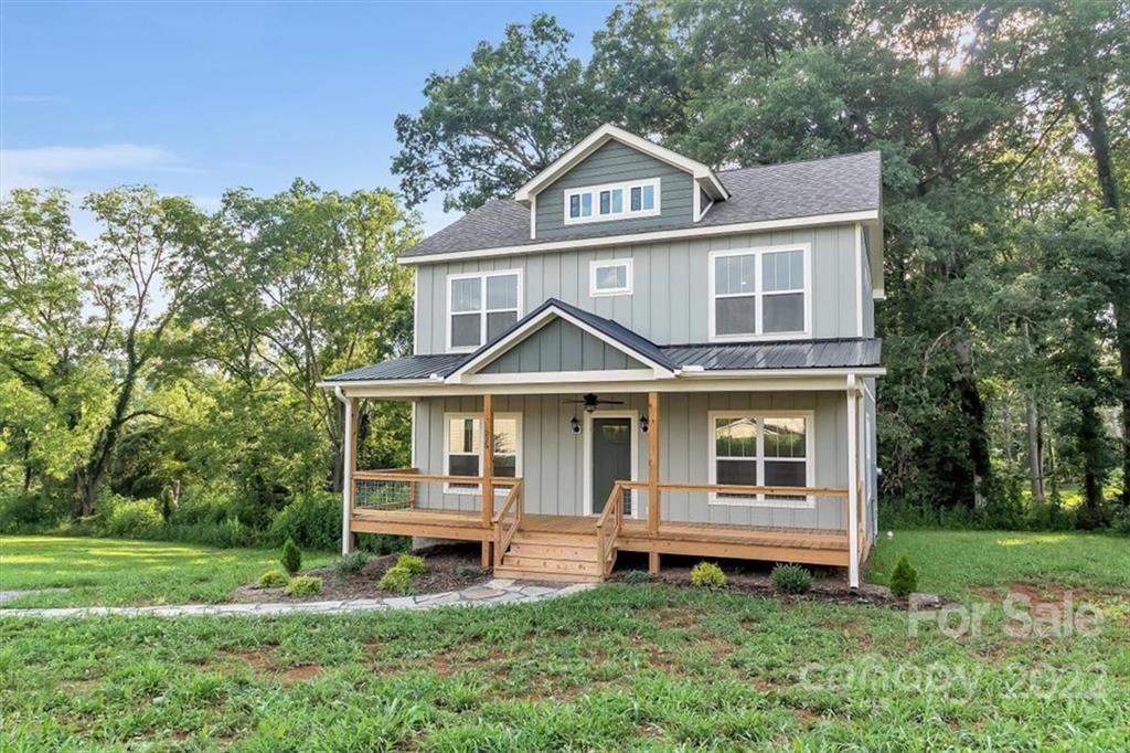 225 Ridge View Drive, Unit 16 Clyde, NC 28721 - Photo 3 of 29 a front view of a house with a yard