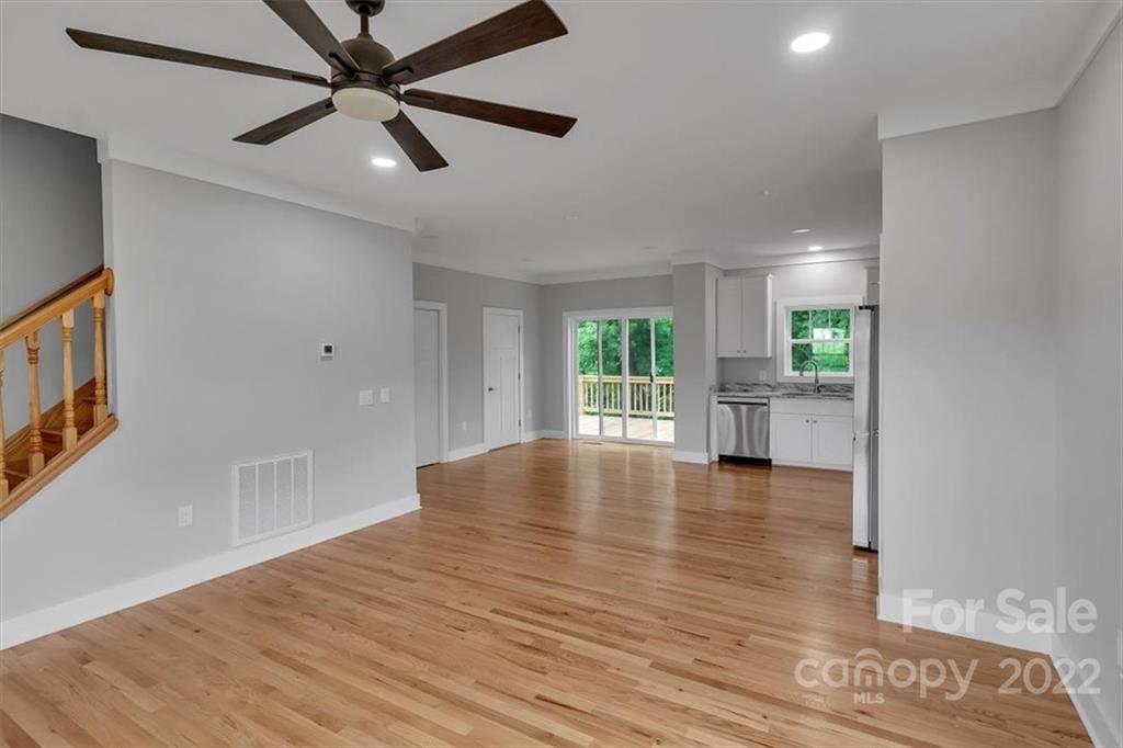 225 Ridge View Drive, Unit 16 Clyde, NC 28721 - Photo 10 of 29 a view of empty room with wooden floor and fan