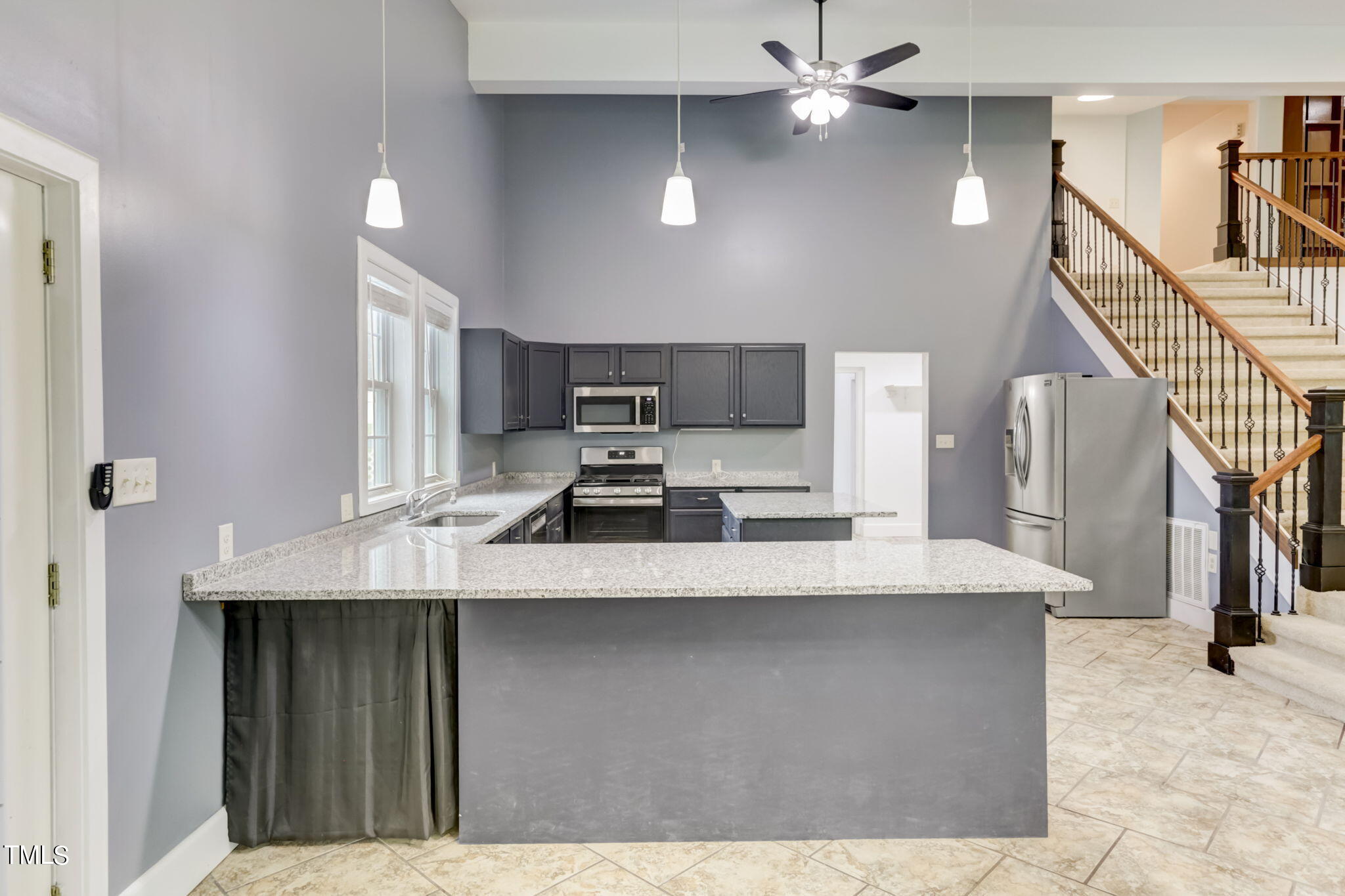 1538 Marly Drive Durham, NC 27703 - Photo 12 of 40 a kitchen with kitchen island a sink stainless steel appliances and cabinets