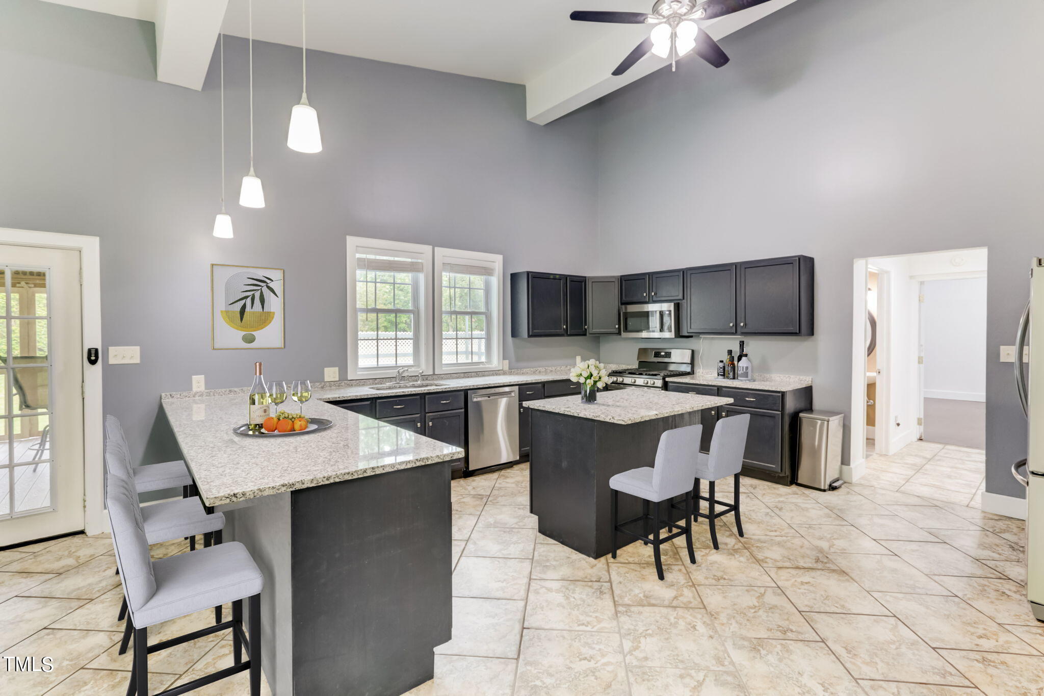 1538 Marly Drive Durham, NC 27703 - Photo 14 of 40 a kitchen with a dining table chairs and refrigerator