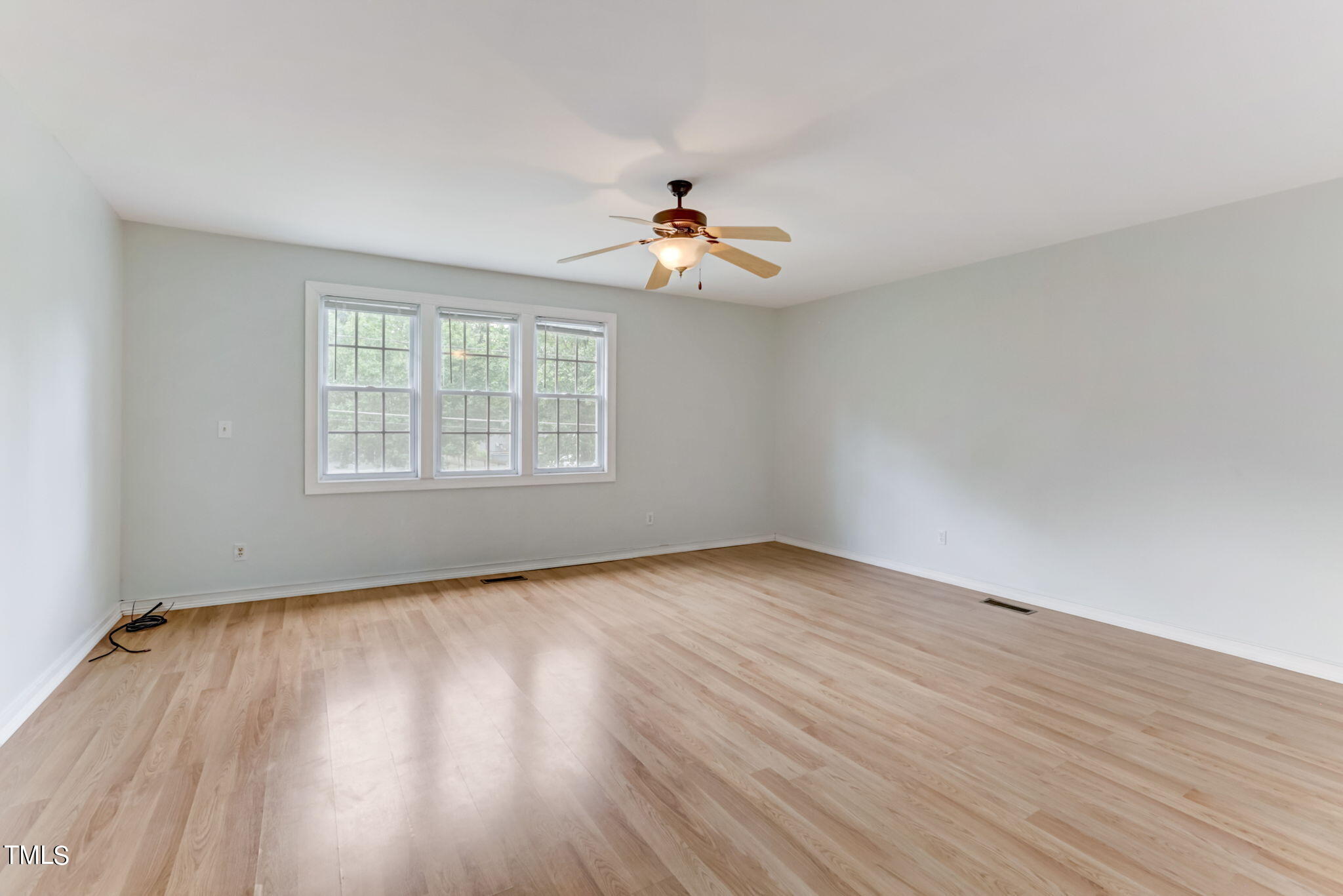 1538 Marly Drive Durham, NC 27703 - Photo 22 of 40 an empty room with wooden floor ceiling fan and windows