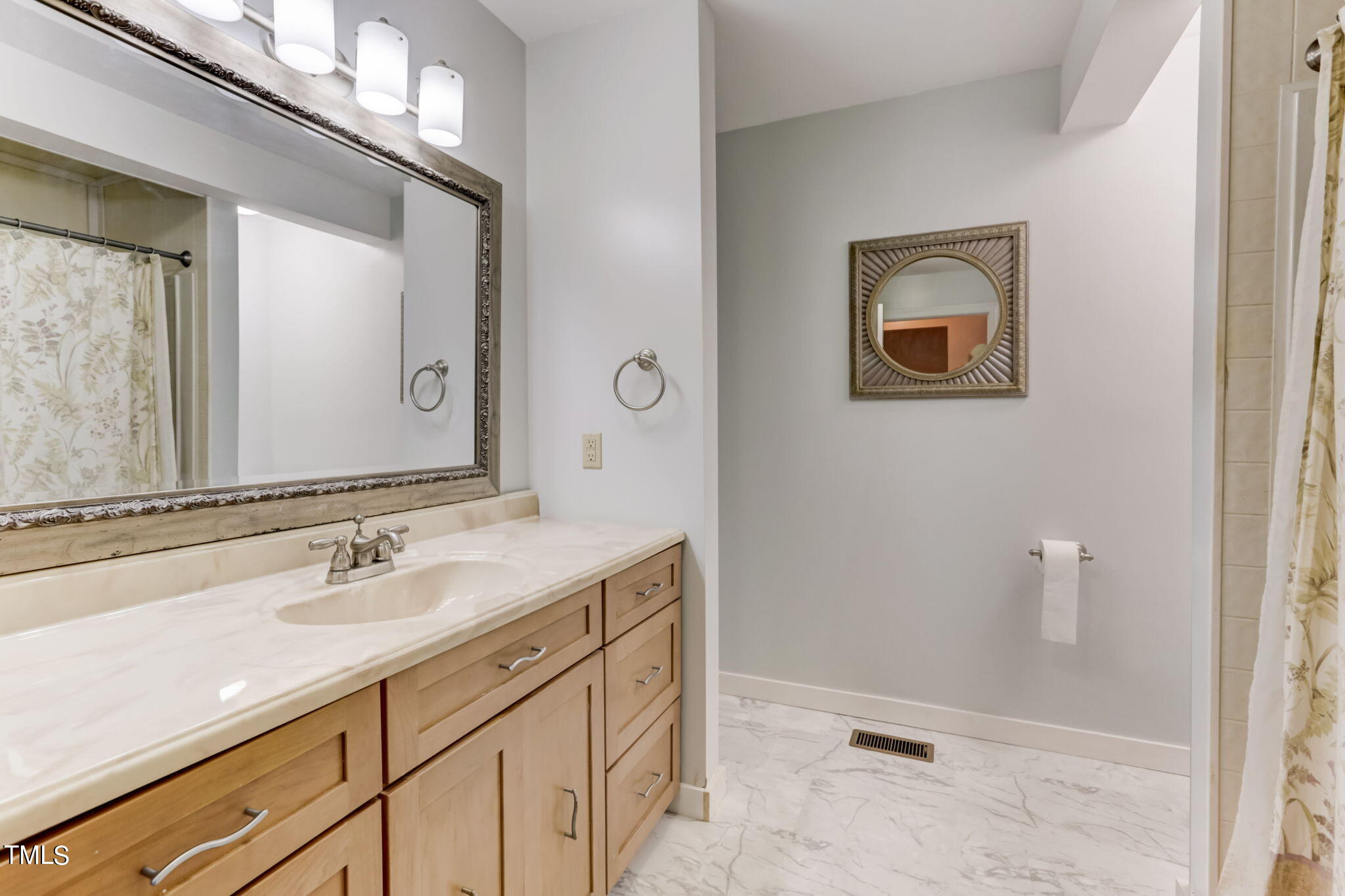 1538 Marly Drive Durham, NC 27703 - Photo 27 of 40 a bathroom with a sink a mirror and a toilet