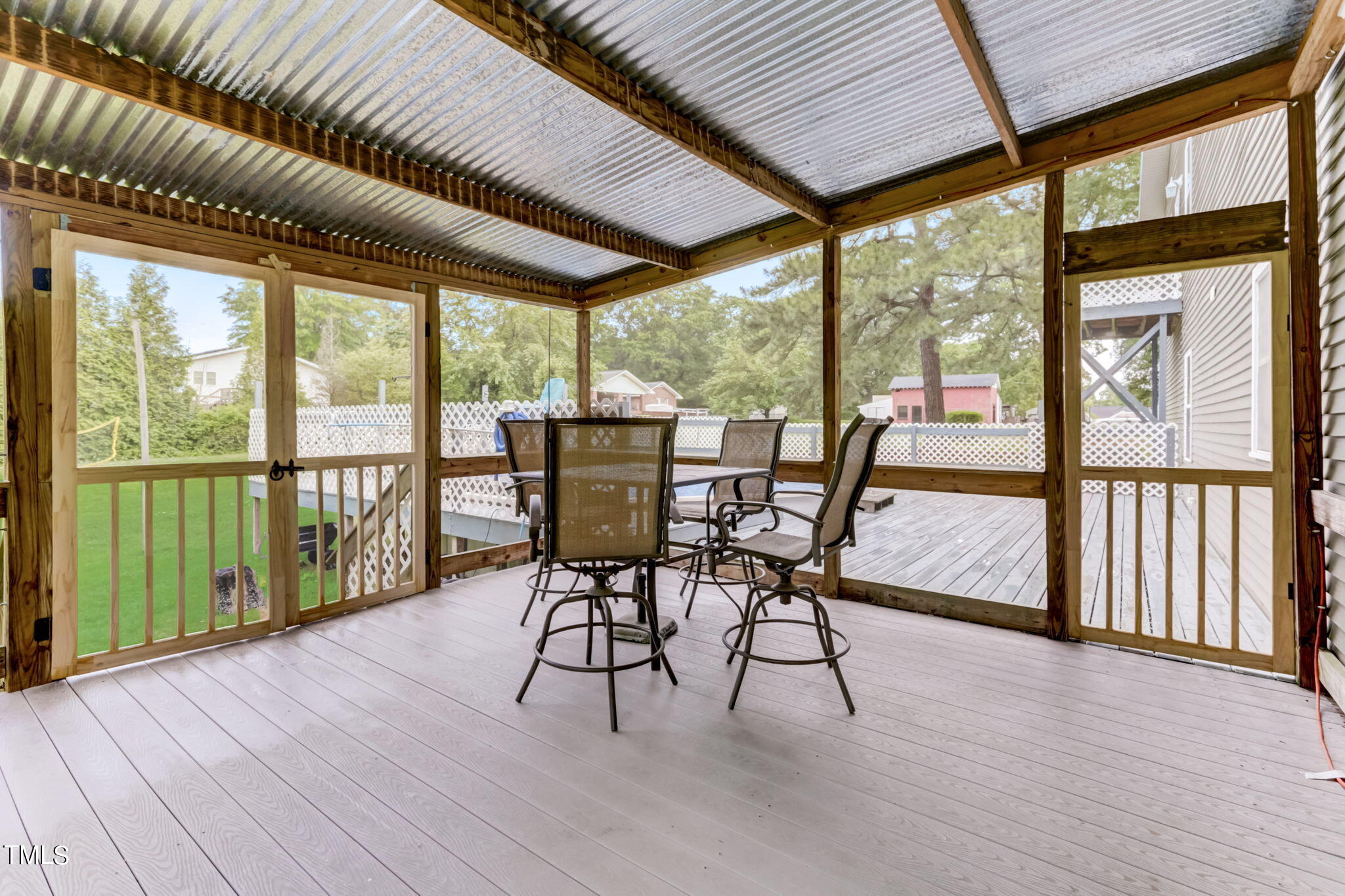 1538 Marly Drive Durham, NC 27703 - Photo 33 of 40 a view of a patio with table and chairs and wooden floor