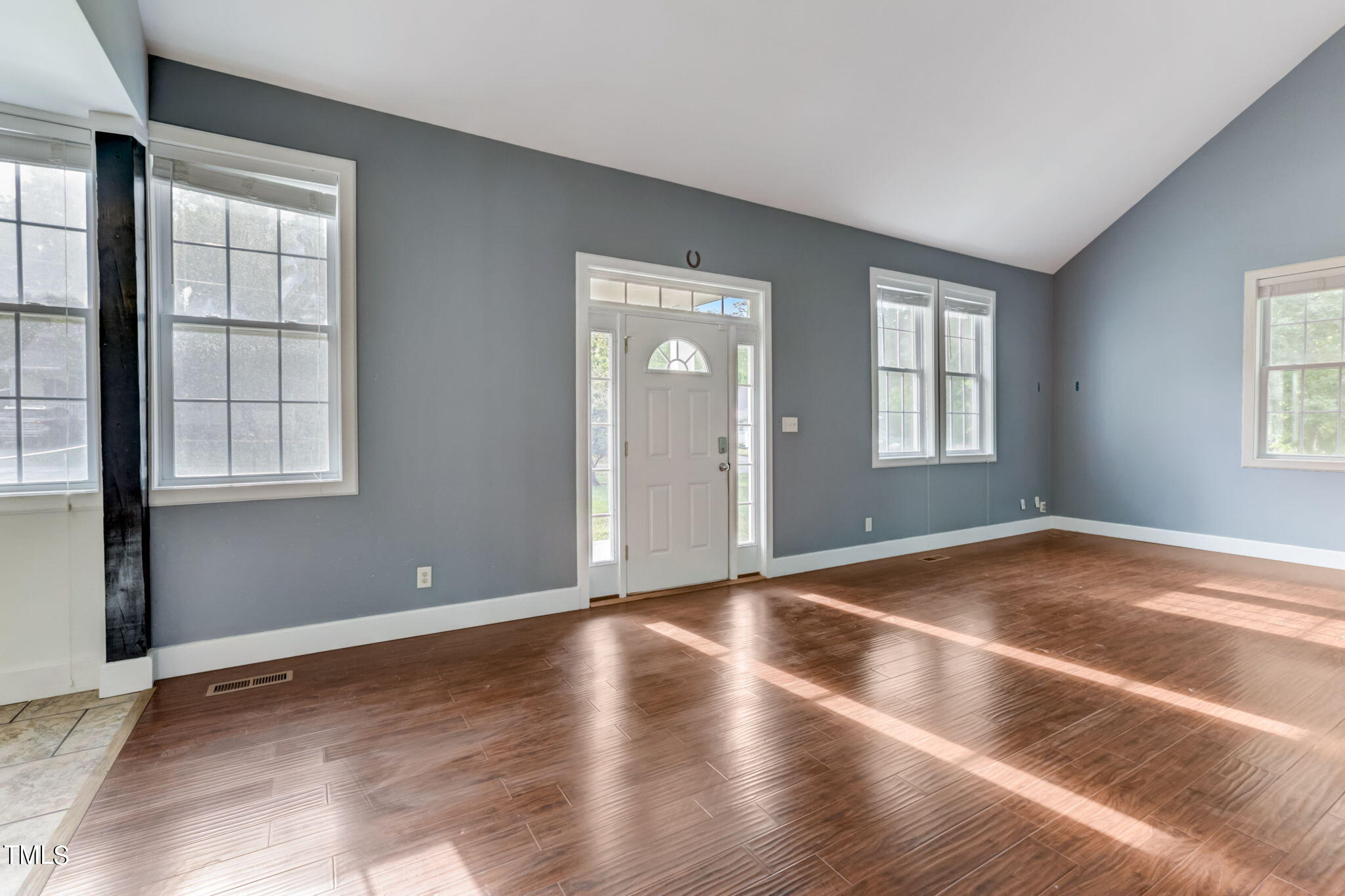 1538 Marly Drive Durham, NC 27703 - Photo 4 of 40 an empty room with wooden floor and windows