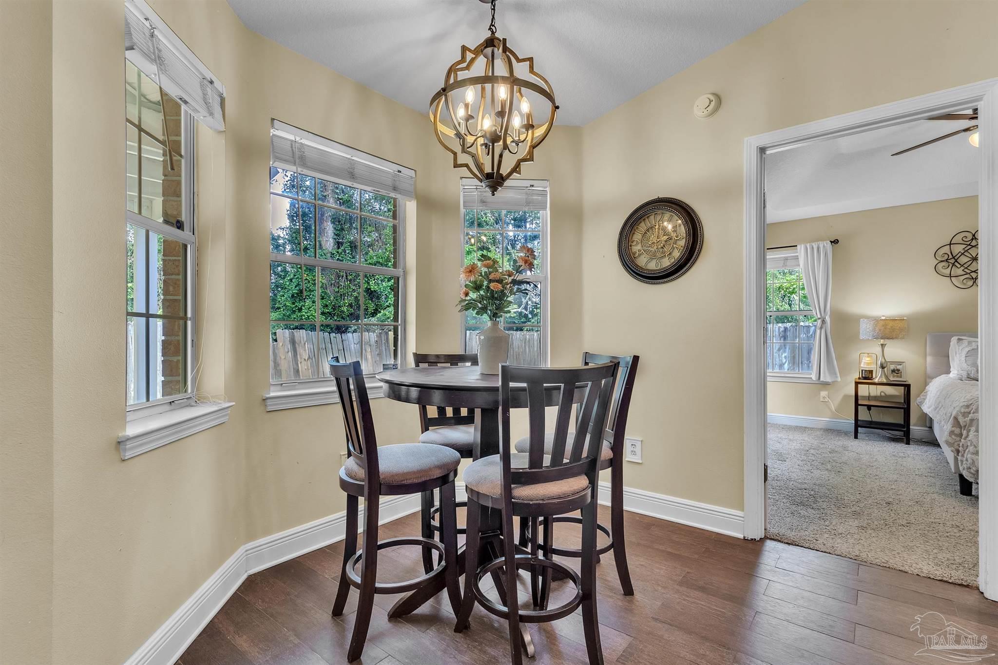 4321 Ridgeland Drive Pace, FL 32571 - Photo 7 of 36 a view of a dining room with furniture window and wooden floor