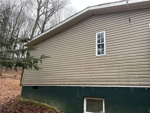 a view of a white house with a small space