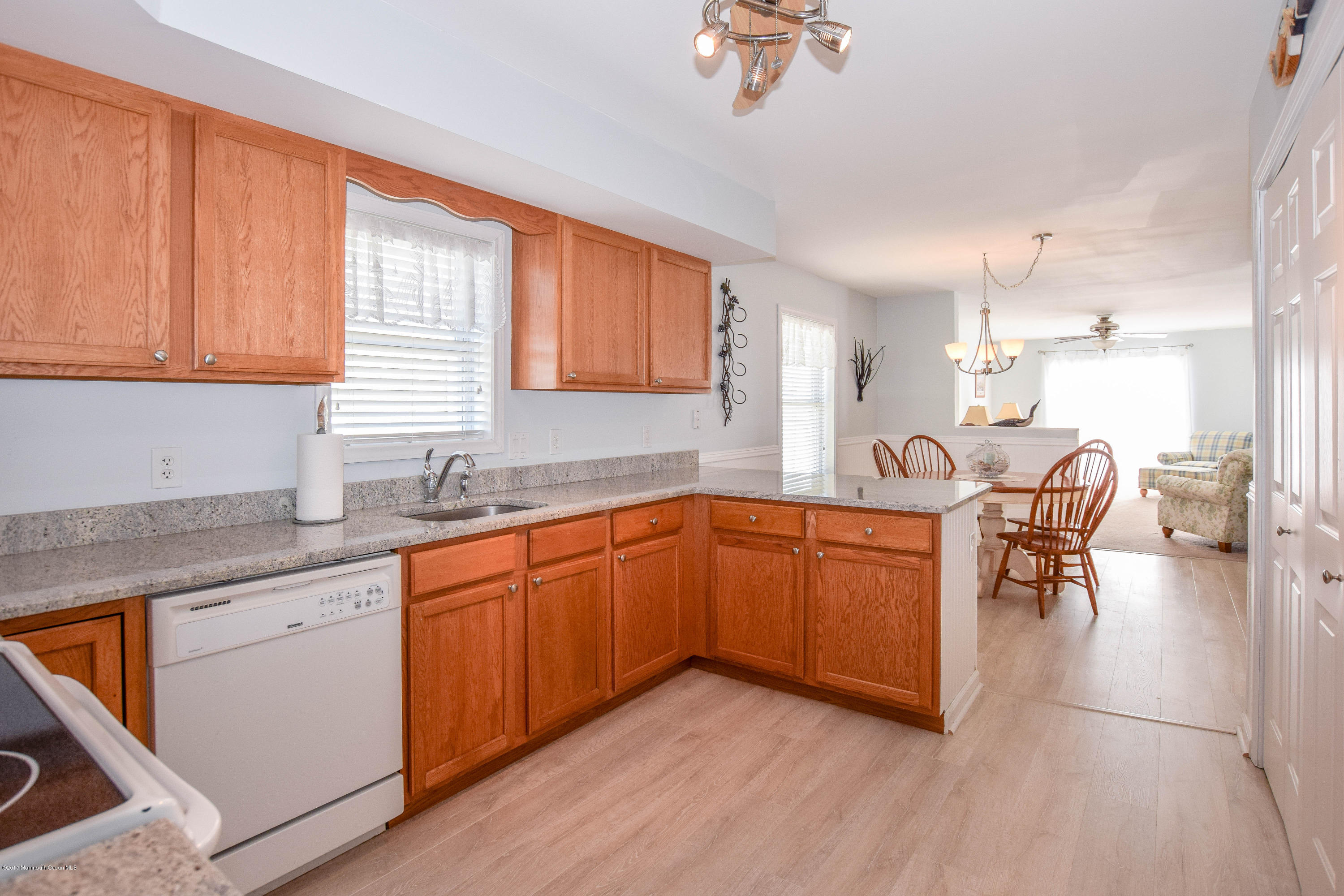 238 Heron Road Tuckerton, NJ 08087 - Photo 16 of 51 a kitchen with stainless steel appliances granite countertop wooden cabinets a dining table and chairs