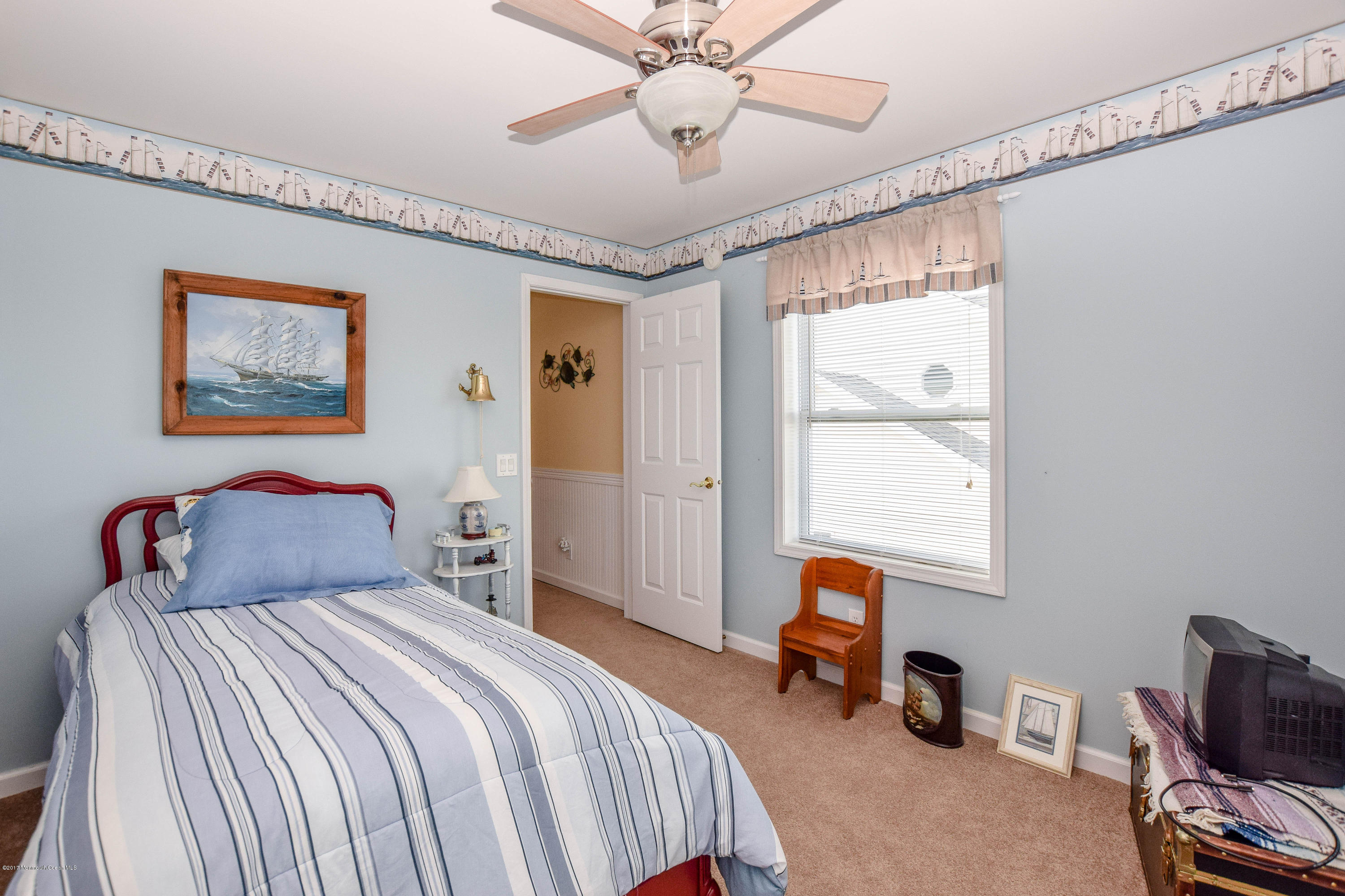 238 Heron Road Tuckerton, NJ 08087 - Photo 27 of 51 a bedroom with a bed and a chandelier