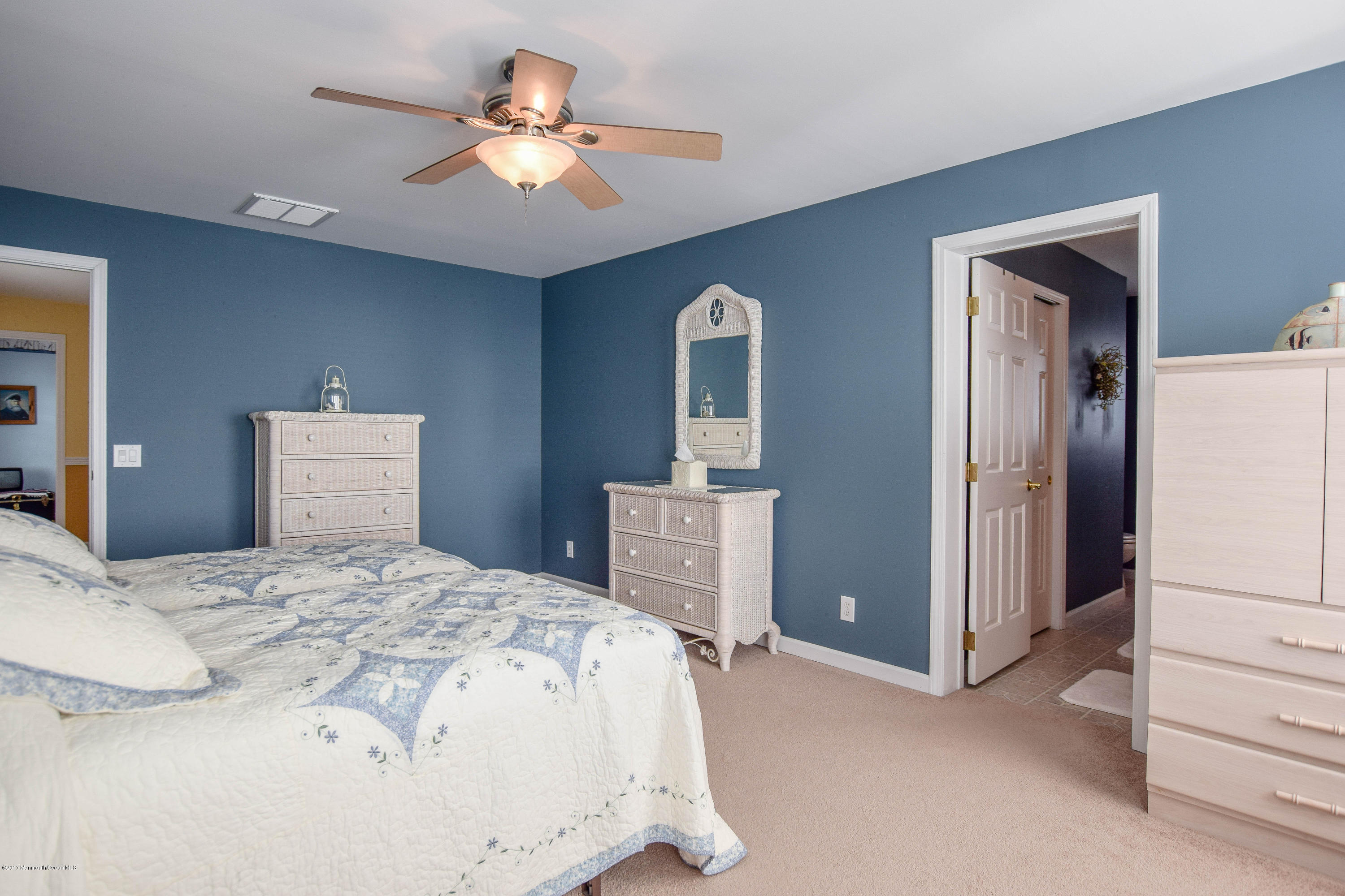 238 Heron Road Tuckerton, NJ 08087 - Photo 32 of 51 a bedroom with a bed and a chandelier