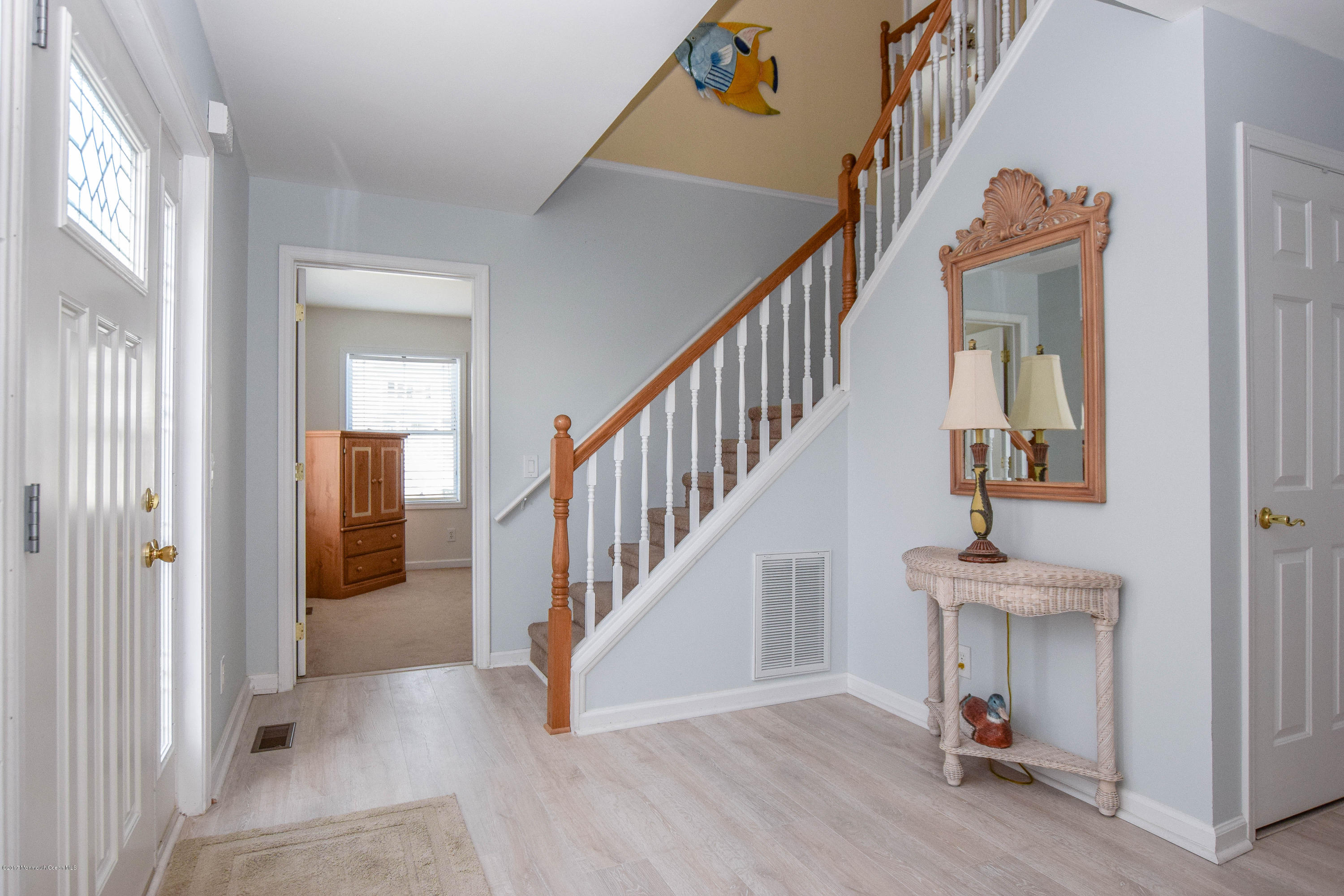 238 Heron Road Tuckerton, NJ 08087 - Photo 5 of 51 a view of a hallway with wooden floor and staircase
