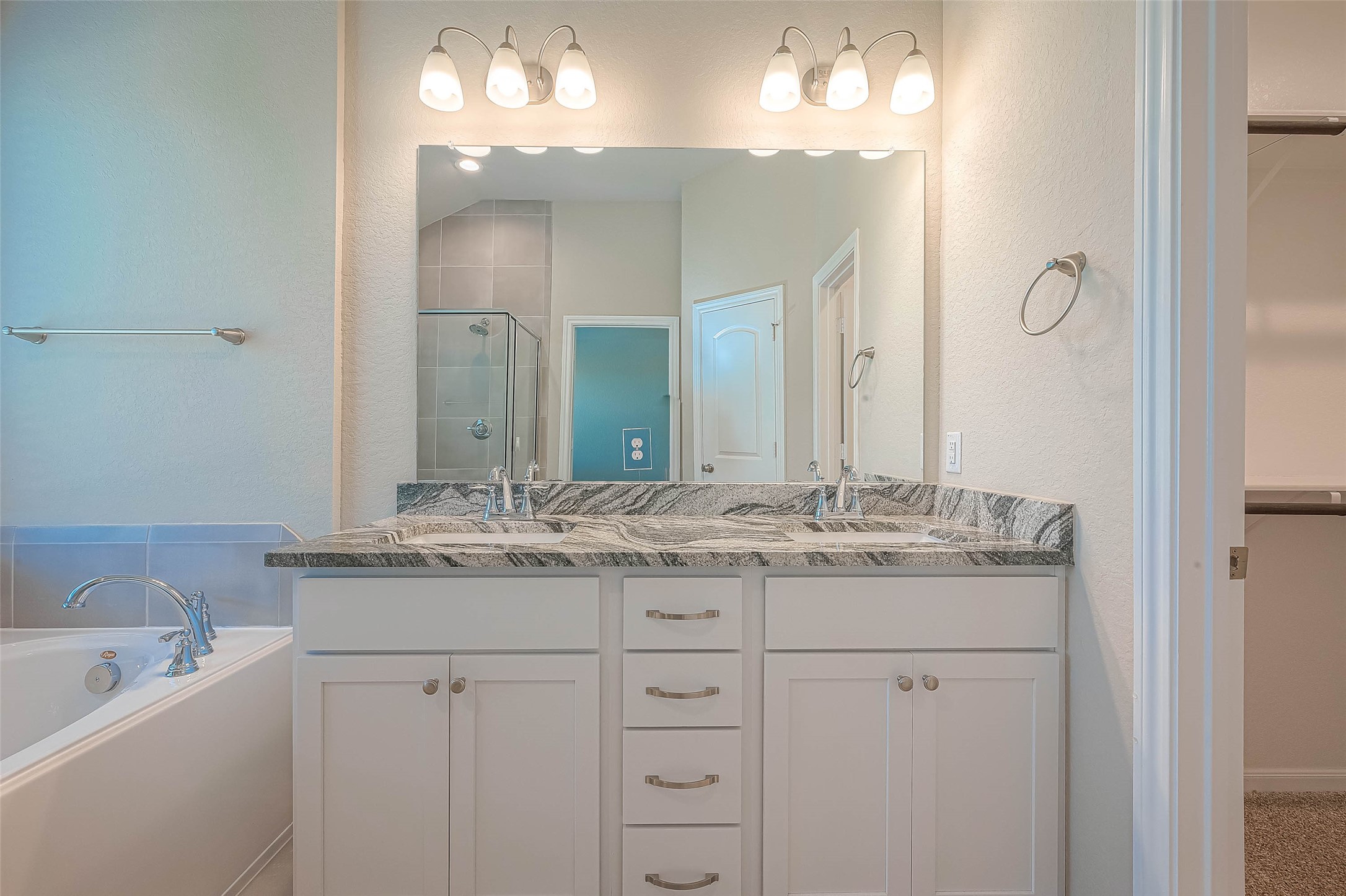 16111 Northern Cardinal Lane Cypress, TX 77433 - Photo 15 of 29 a bathroom with a granite countertop sink double vanity and a mirror