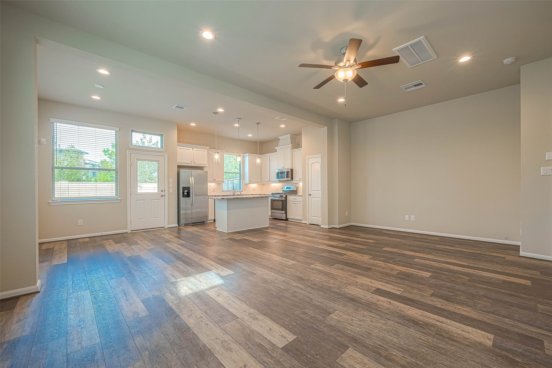 16111 Northern Cardinal Lane Cypress, TX 77433 - Photo 2 of 29 a view of an empty room with wooden floor and a window