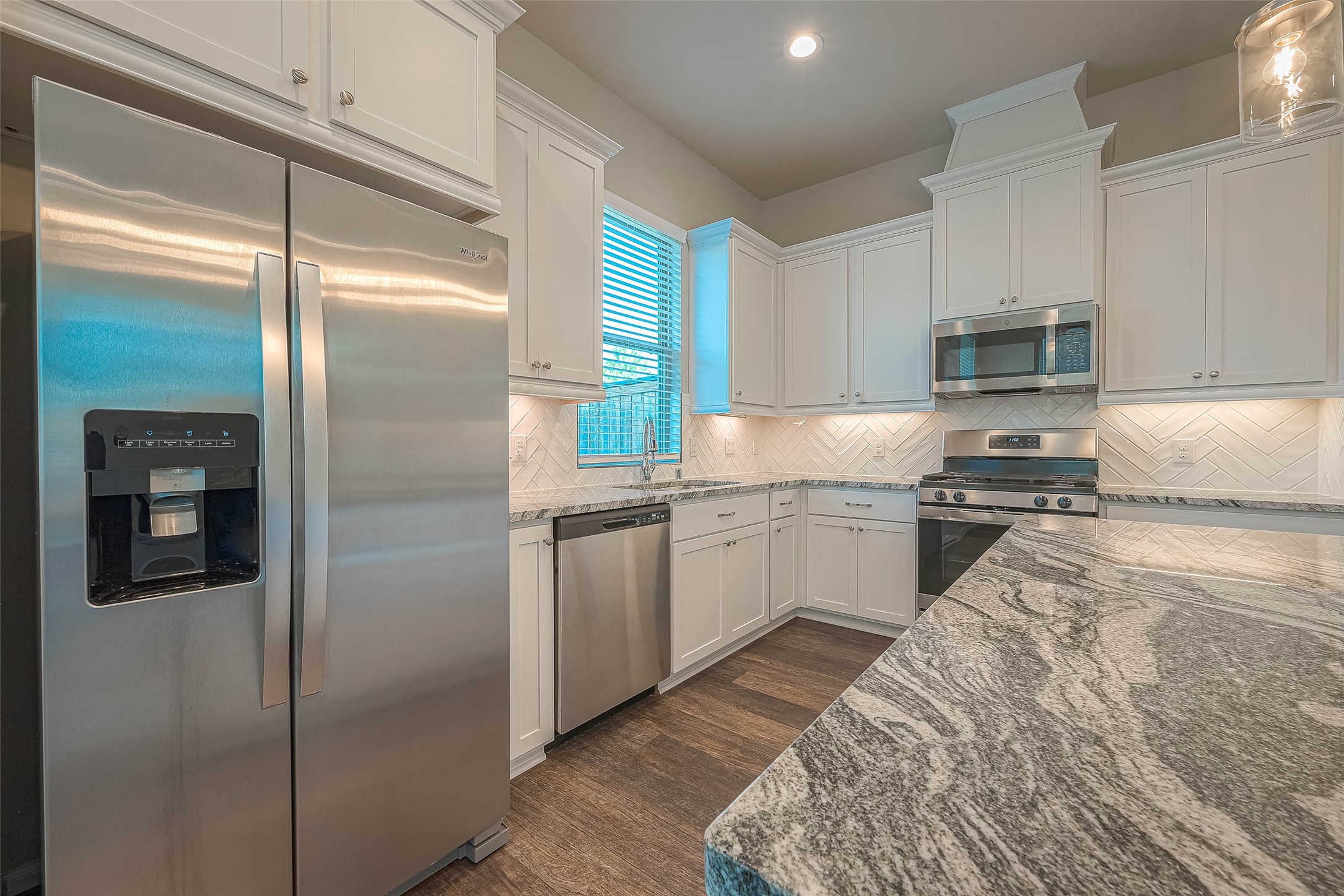 16111 Northern Cardinal Lane Cypress, TX 77433 - Photo 8 of 29 a kitchen with granite countertop a refrigerator and a sink