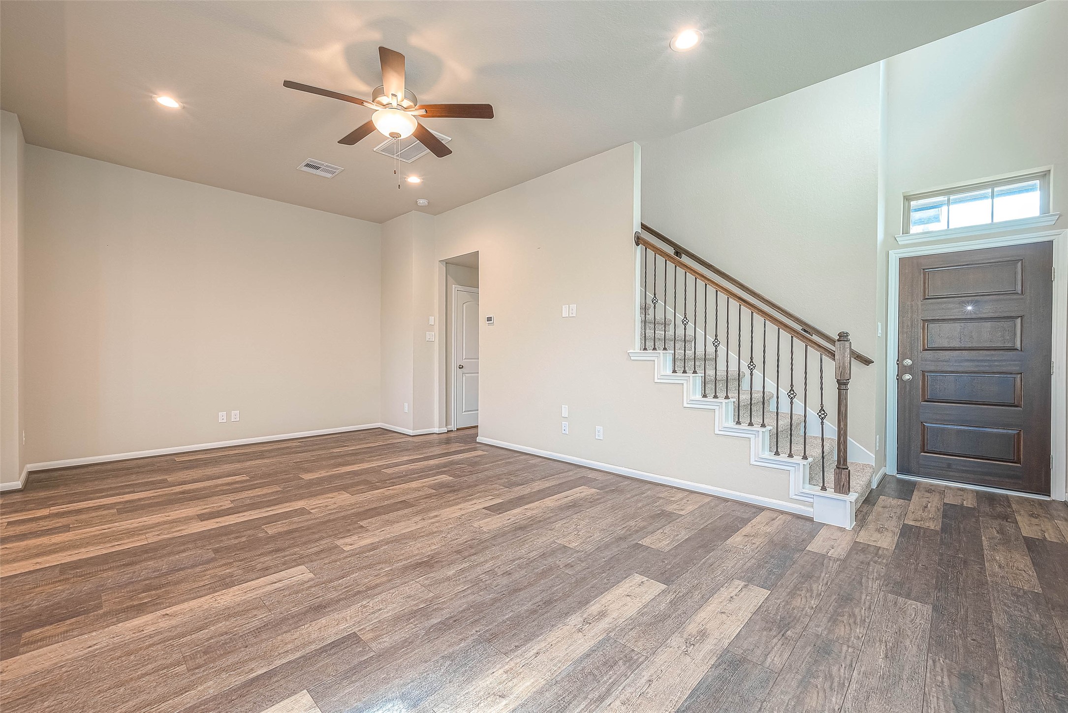 16111 Northern Cardinal Lane Cypress, TX 77433 - Photo 9 of 29 wooden floor in an empty room with a ceiling fan