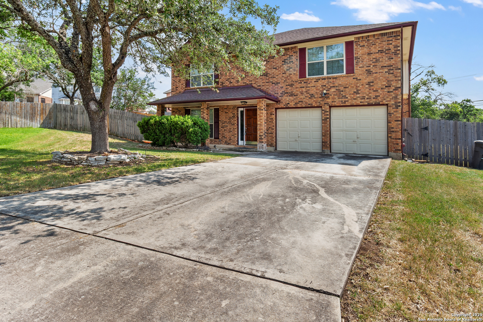 25002 Silverstone San Antonio, TX 78258 - Photo 1 of 26 a front view of a house with a yard and garage