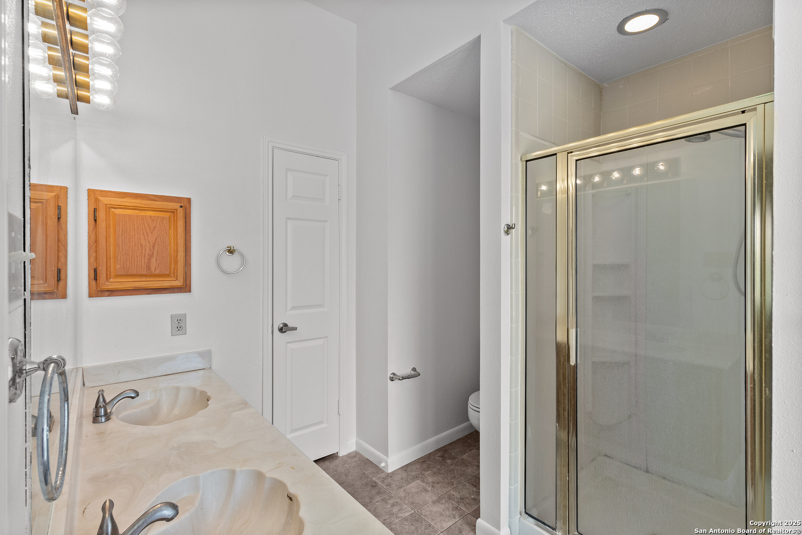 25002 Silverstone San Antonio, TX 78258 - Photo 16 of 26 a bathroom with a tub and shower