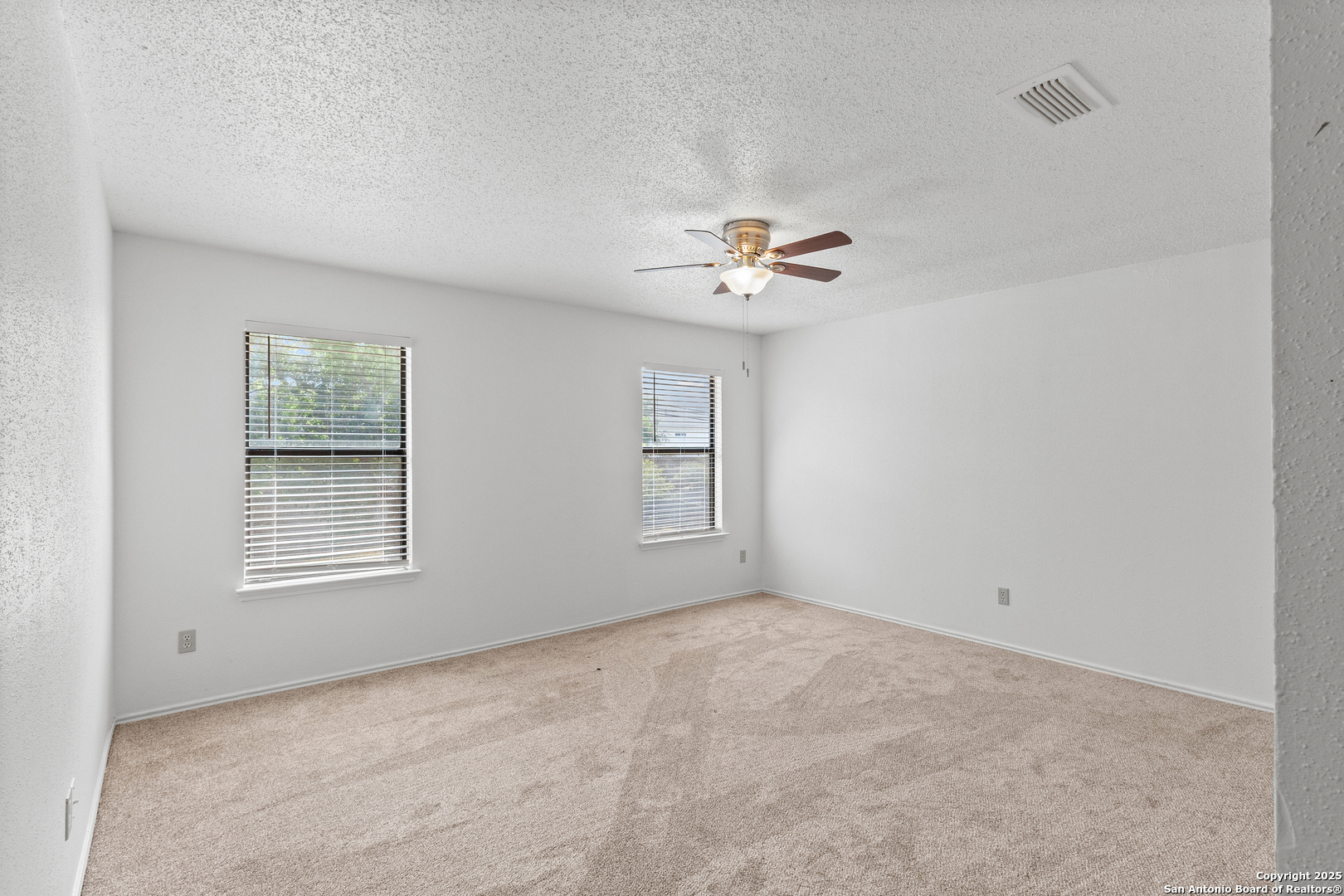 25002 Silverstone San Antonio, TX 78258 - Photo 17 of 26 a view of an empty room with a window