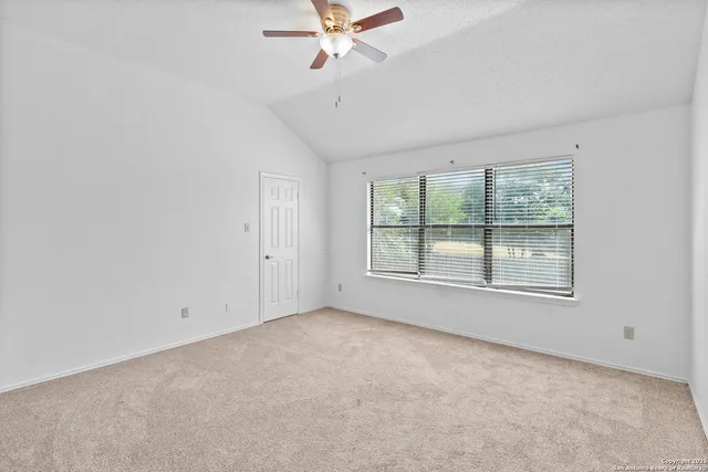 a view of an empty room with a window