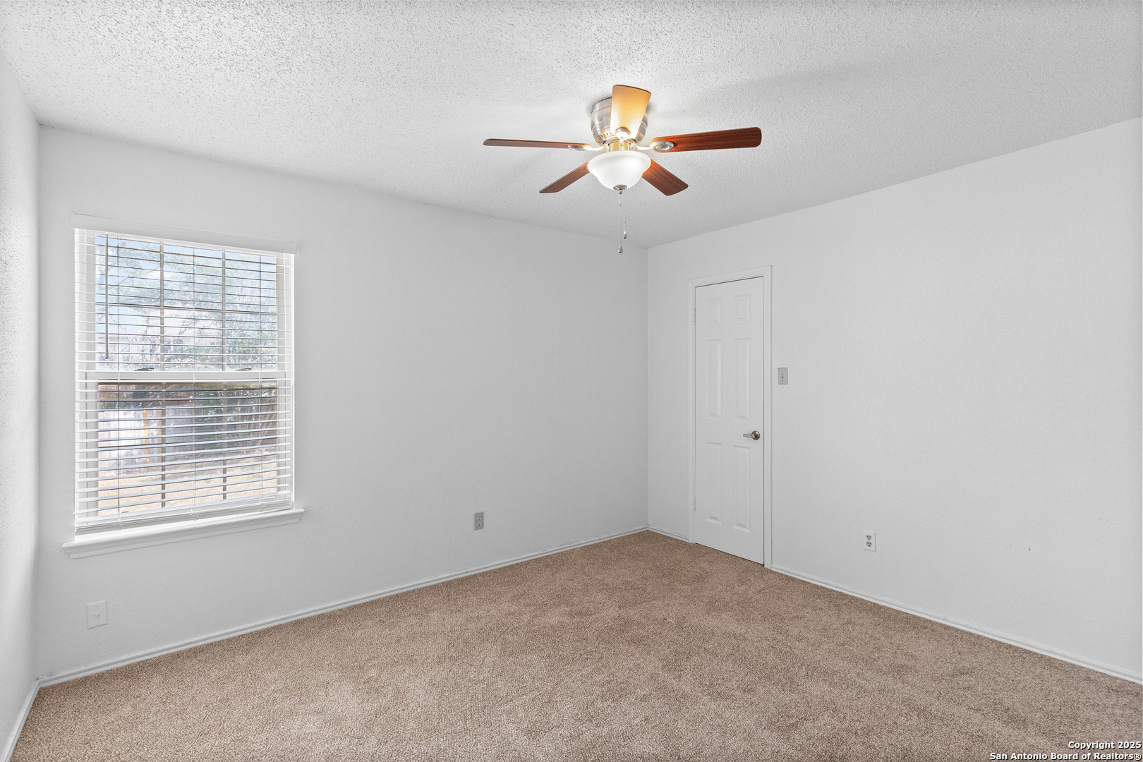 25002 Silverstone San Antonio, TX 78258 - Photo 19 of 26 an empty room with windows and fan