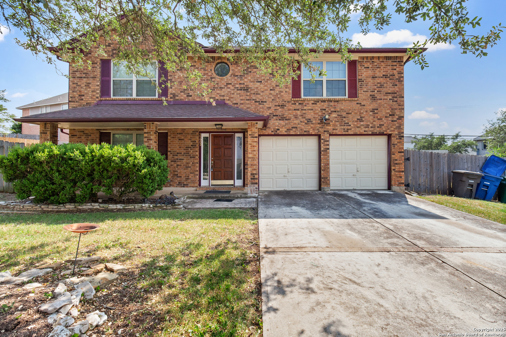 25002 Silverstone San Antonio, TX 78258 - Photo 2 of 26 a front view of a house with a yard and garage