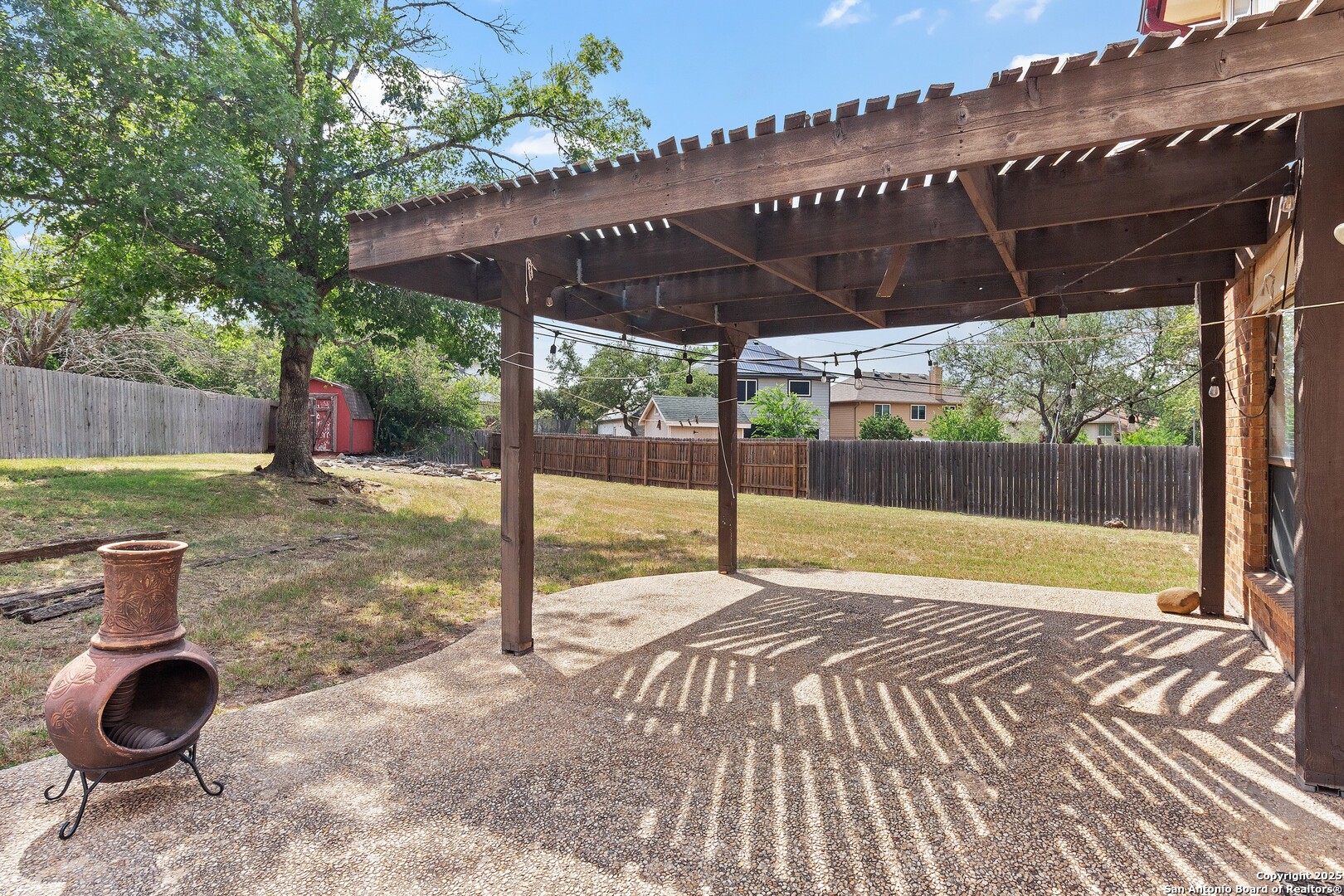 25002 Silverstone San Antonio, TX 78258 - Photo 22 of 26 a view of a patio with table and chairs under an umbrella