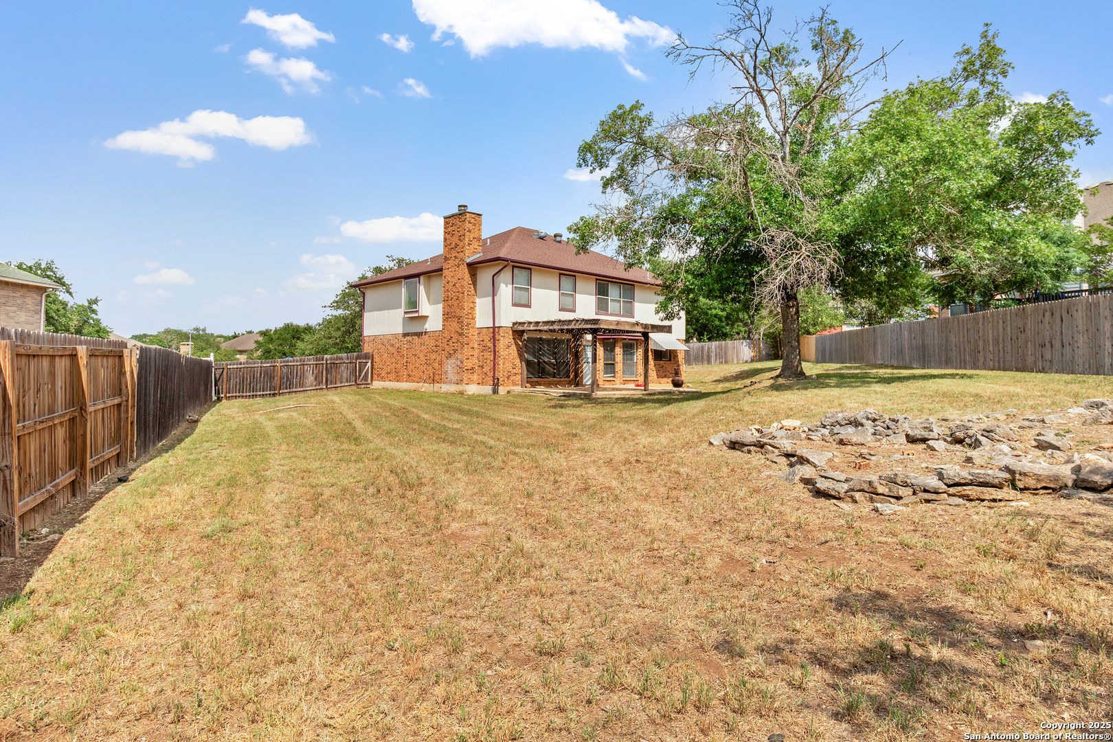 25002 Silverstone San Antonio, TX 78258 - Photo 24 of 26 a view of a house with a yard