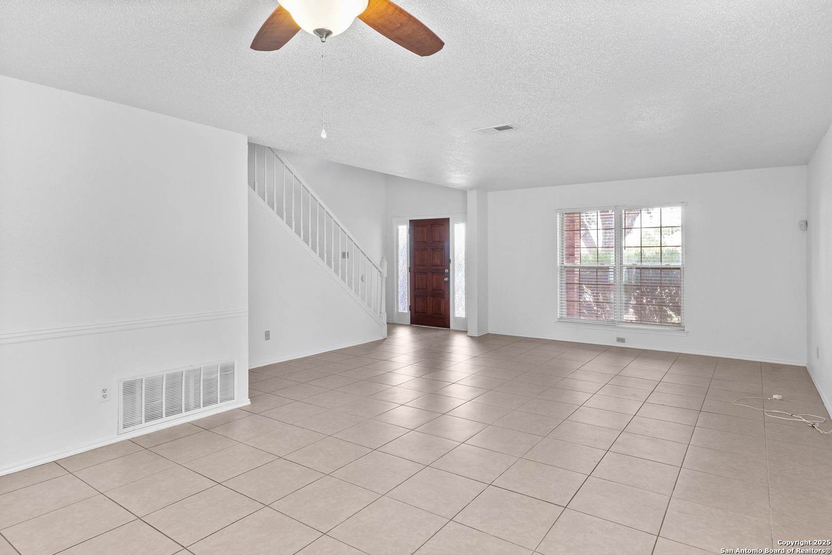 25002 Silverstone San Antonio, TX 78258 - Photo 4 of 26 a view of an empty room with a window