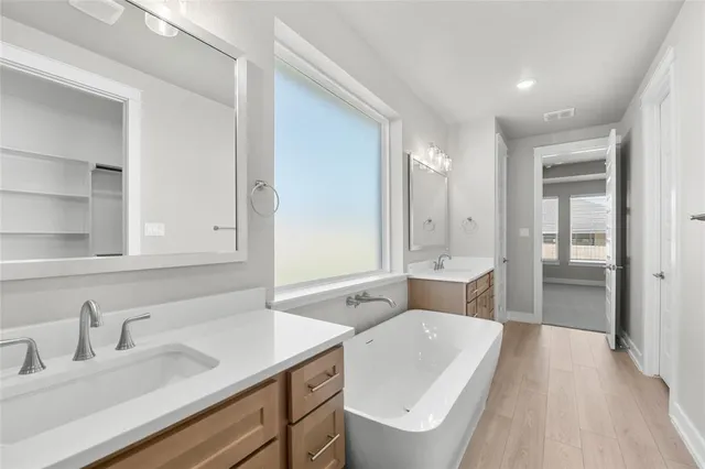 a bathroom with a sink a mirror and a bathtub