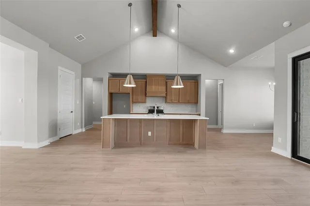 a large room with a large window and stainless steel appliances
