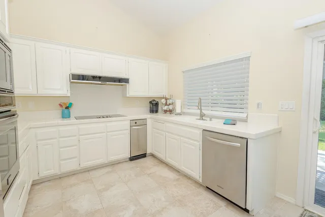 a front view of a house with a yard and a garden