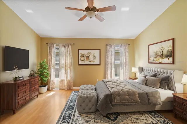 a bedroom with a large bed and a flat screen tv