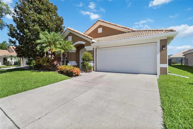 a front view of a house with a yard and garage