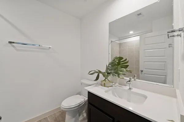a bathroom with a sink toilet and a mirror
