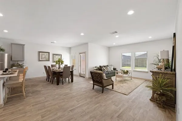 a living room with furniture and a wooden floor