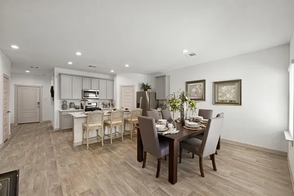 a view of a dining room with furniture and wooden floor