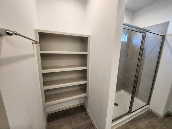 a view of walk in closet with empty racks