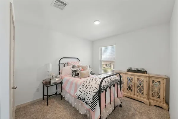 a bedroom with a bed and a night stand