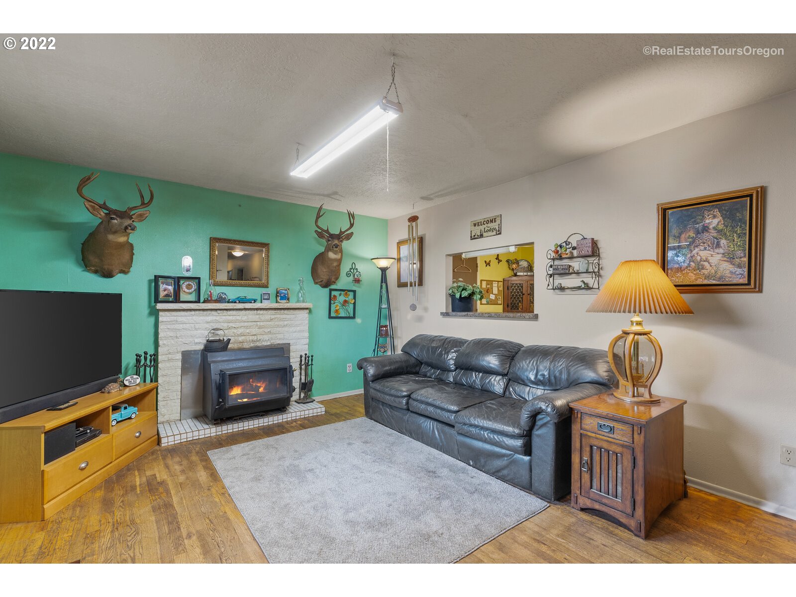 48780 Southeast Baty Road Sandy, OR 97055 - Photo 4 of 32 a living room with furniture a flat screen tv and a fireplace