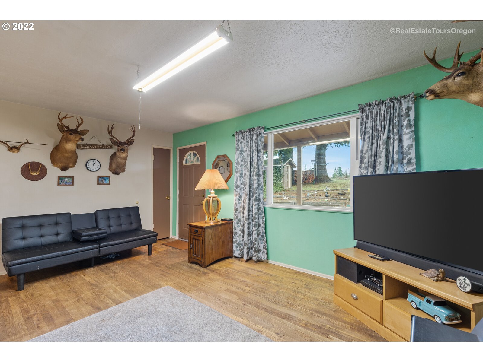 48780 Southeast Baty Road Sandy, OR 97055 - Photo 6 of 32 a living room with furniture and a flat screen tv