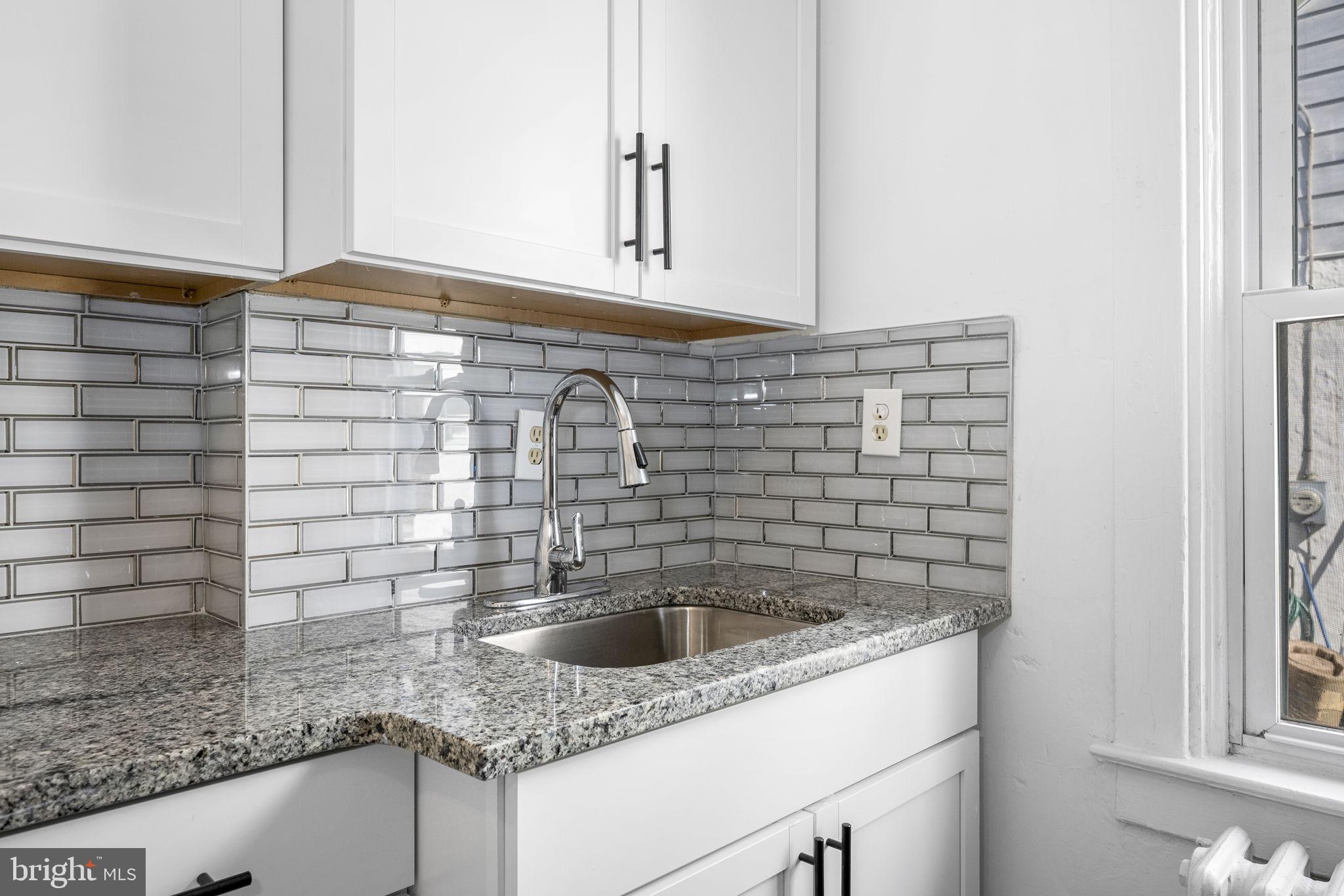 246 Powell Road Springfield, PA 19064 - Photo 9 of 29 a kitchen with a sink and a window
