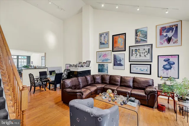a living room with furniture and painting on the wall