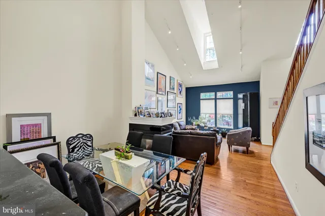a view of a dining room with furniture a rug and wooden floor