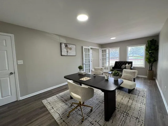 a living room with furniture and wooden floor