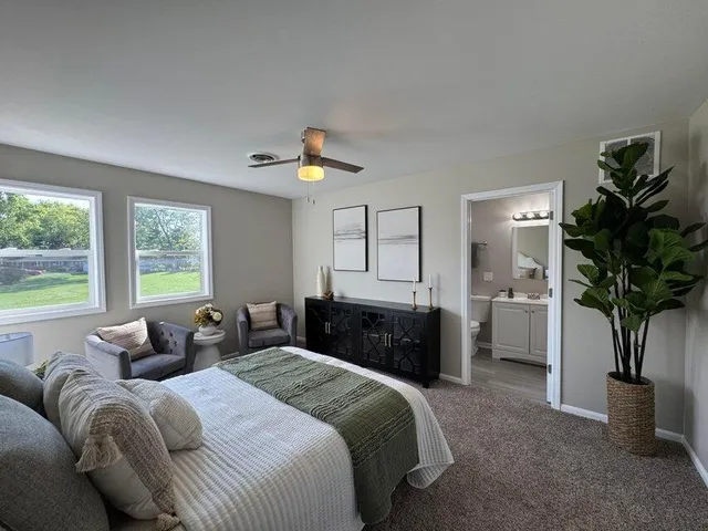 a bathroom with a toilet sink a shower and mirror