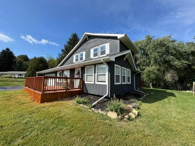 a front view of a house with a yard table and chairs