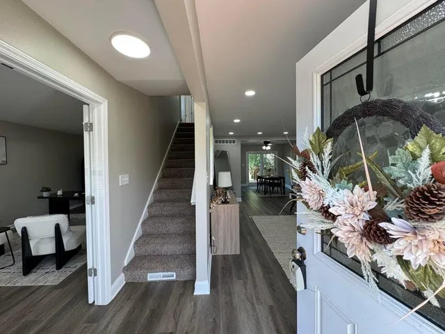 a view of entryway and hall with wooden floor