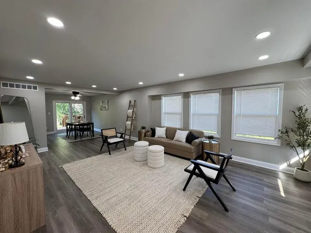 a living room with furniture and a wooden floor