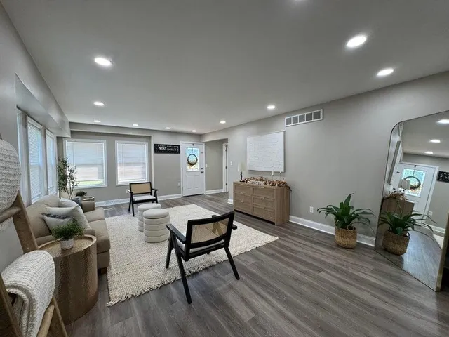 a living room with furniture and wooden floor